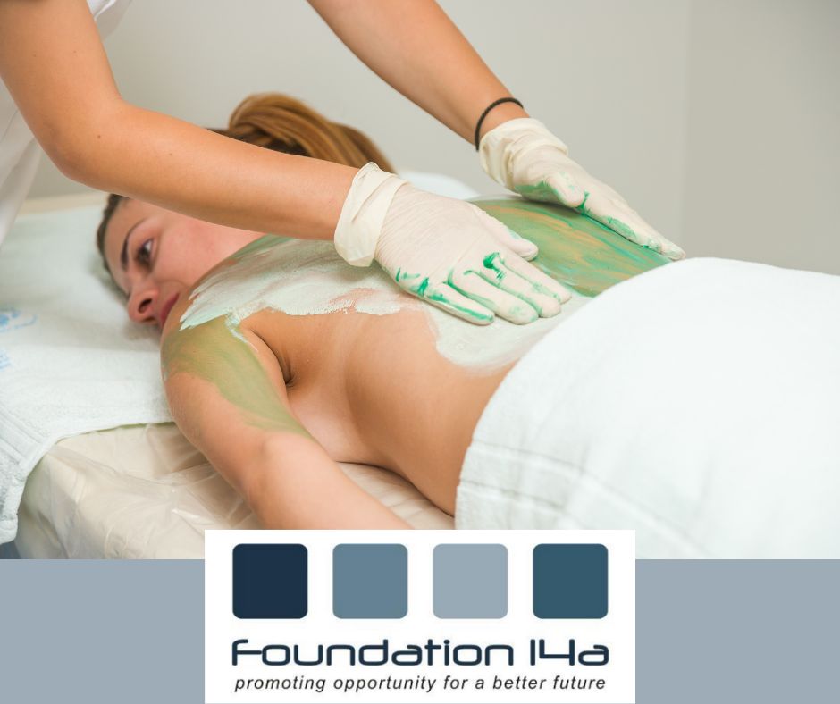 The Alliance of Beauty Practitioners - A lady face down on massage table being massaged with clay treatment