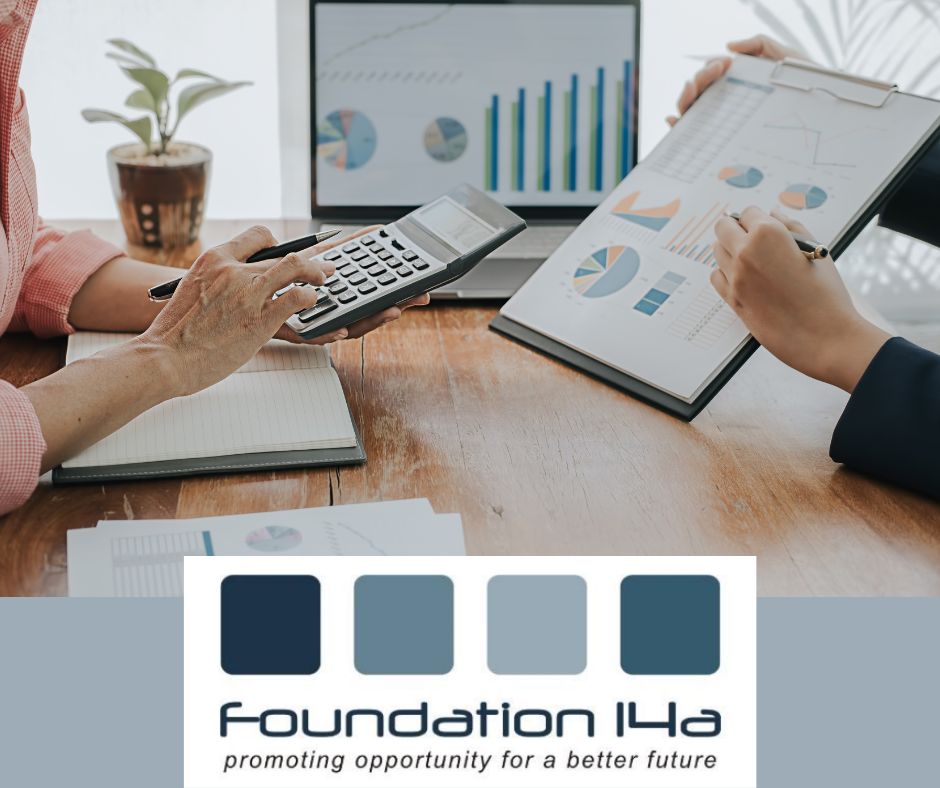 Close up of 2 people discussing data over a desk with files and a computer screen