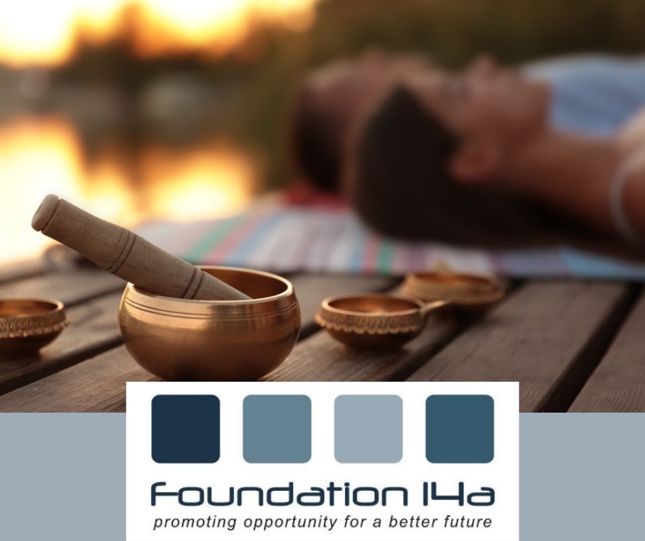 Foundation 14a 2 people blurred in the background lying down at an outdoor spar, pestle and mortar in the foreground