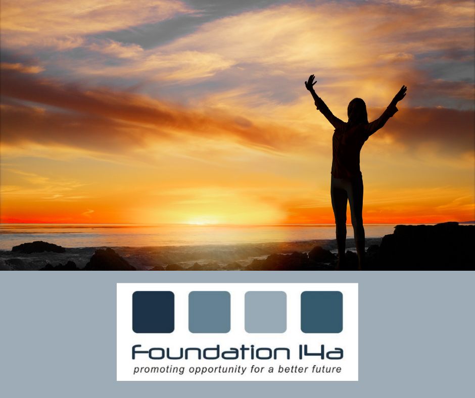 Empowering Wellness, the silhouette of a lady, raised arms, stood on a coastline against a a beautiful orange sunset