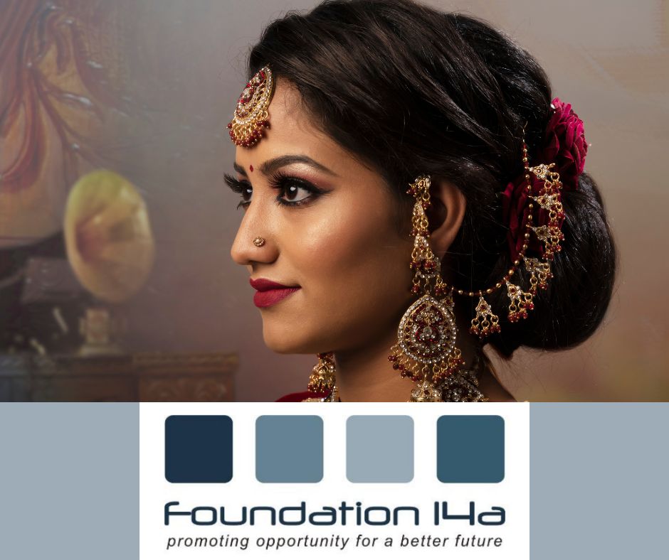 An Indian lady is in side profile. She is adorned in jewellery and has beautiful eye makeup and facial makeup