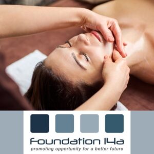 Student on a Facial Treatment Beauty Course applying massage to a model's chin as she lies on a treatment bed