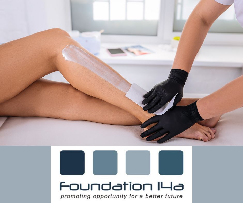 A pair of legs, the right leg has white substance applied to it, a beautician's hands are visible holding a strip over the substance, ready to wax