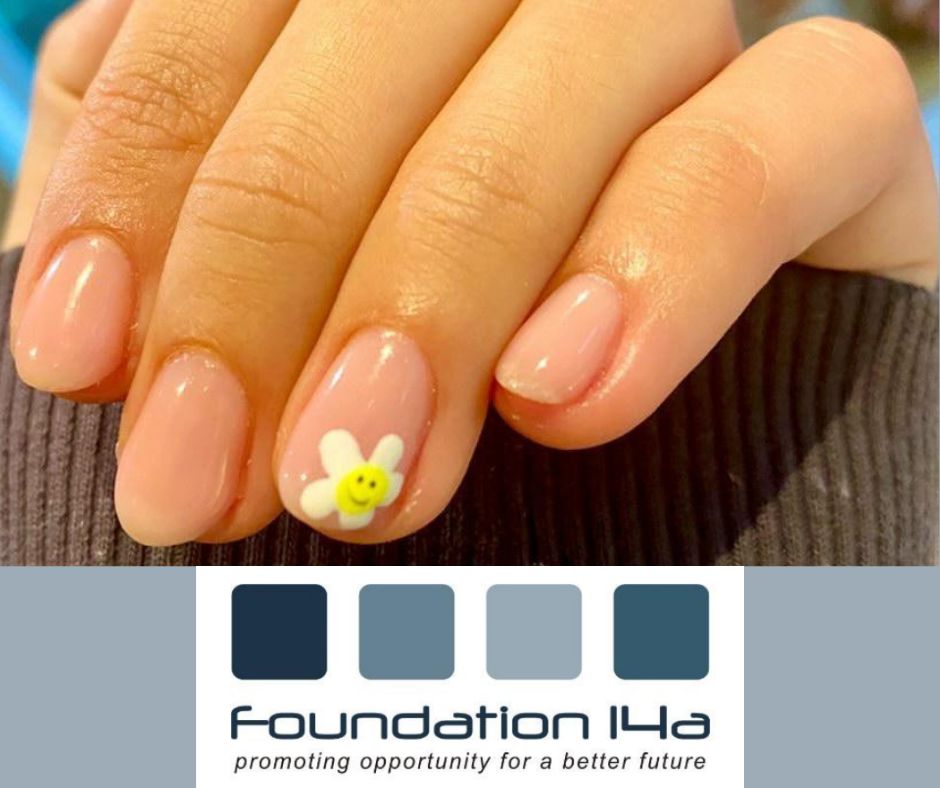 Close up of a hand with natural coloured nail polish and a white, daisy flower design painted on the ring finger