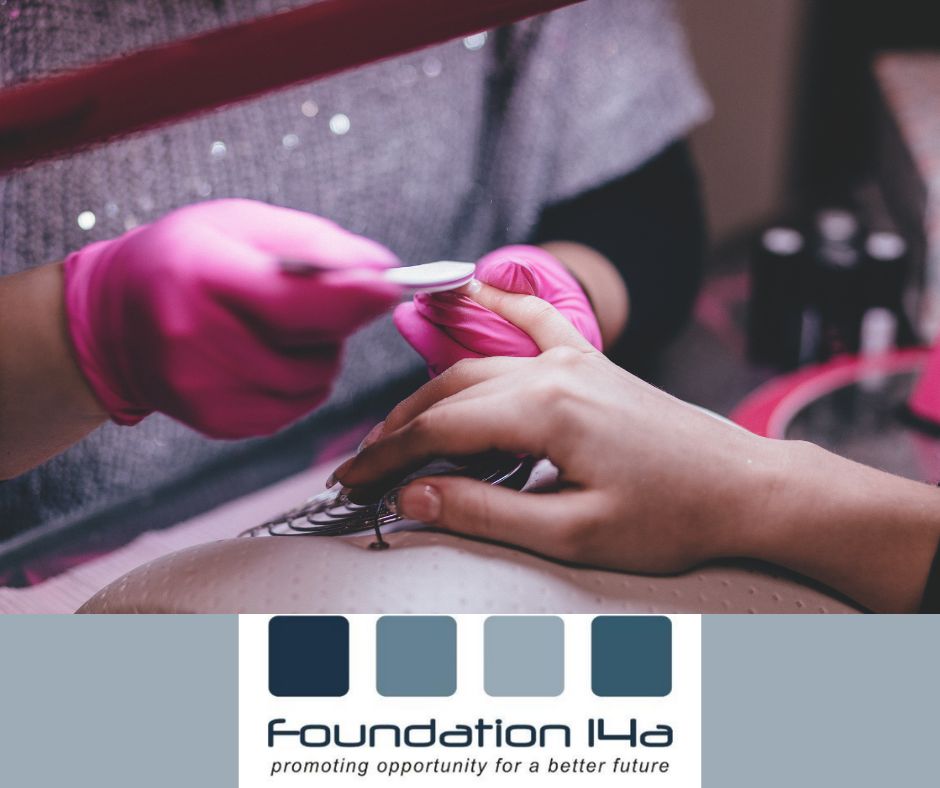 Beauty Courses - close up of a nail technician's pink gloved hands holding a client's hand and filing the nails