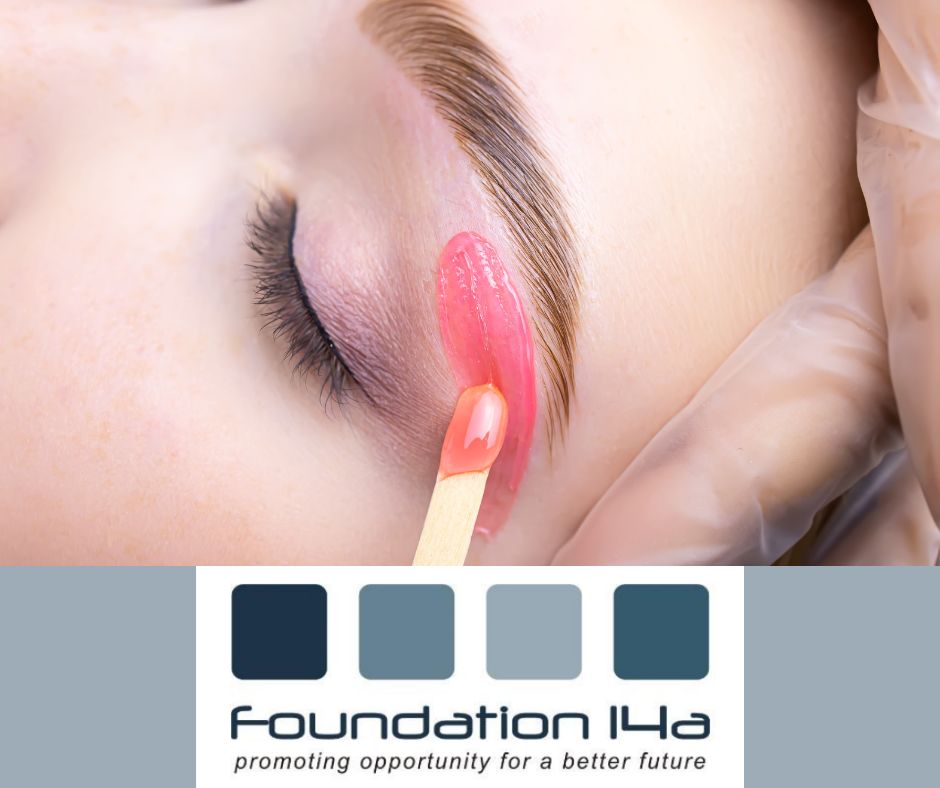 Close up of pink wax being applied under a model's eyebrow on the eyebrow waxing course