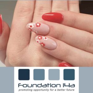 Close up of nails with red and flowers on some created during the nail art training course