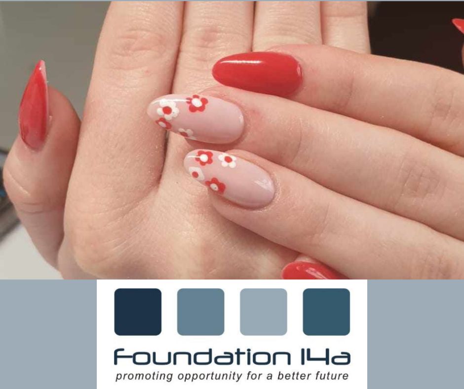 Close up of nails with red and flowers on some created during the nail art training course