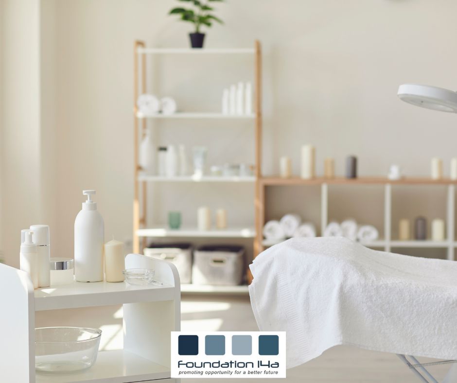 We visit your salon for our beauty courses, like this one, with a treatment table covered in a white towel and shelving housing products.