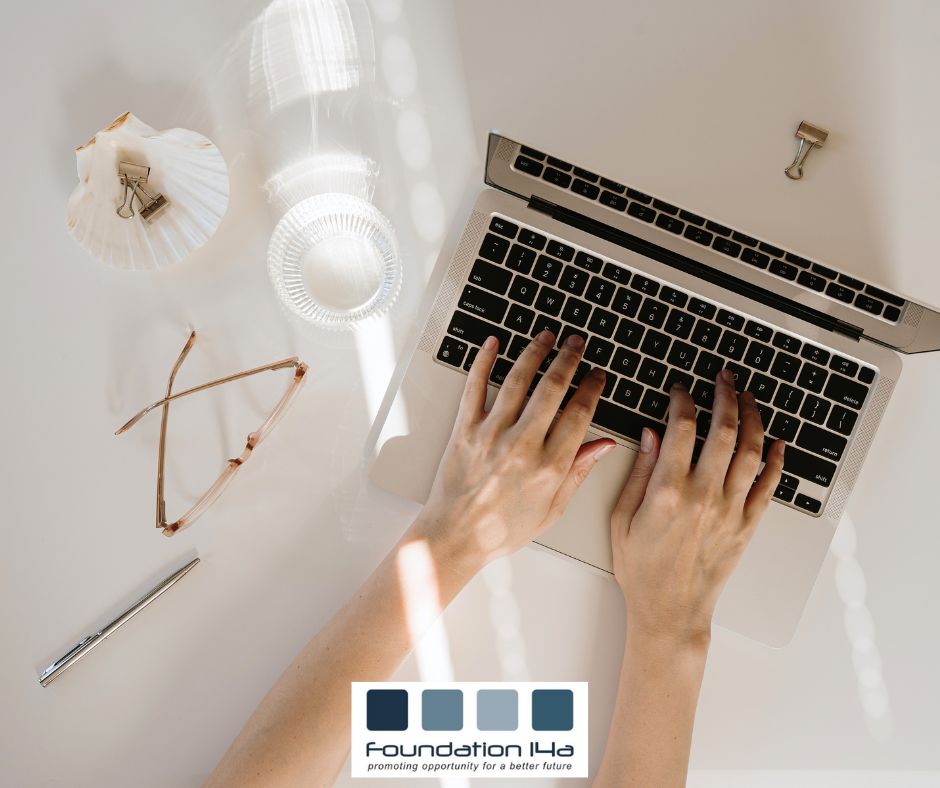 Business courses represented here by an overhead shot of hands typing on a laptop keyboard with a glass of water and glasses to the left