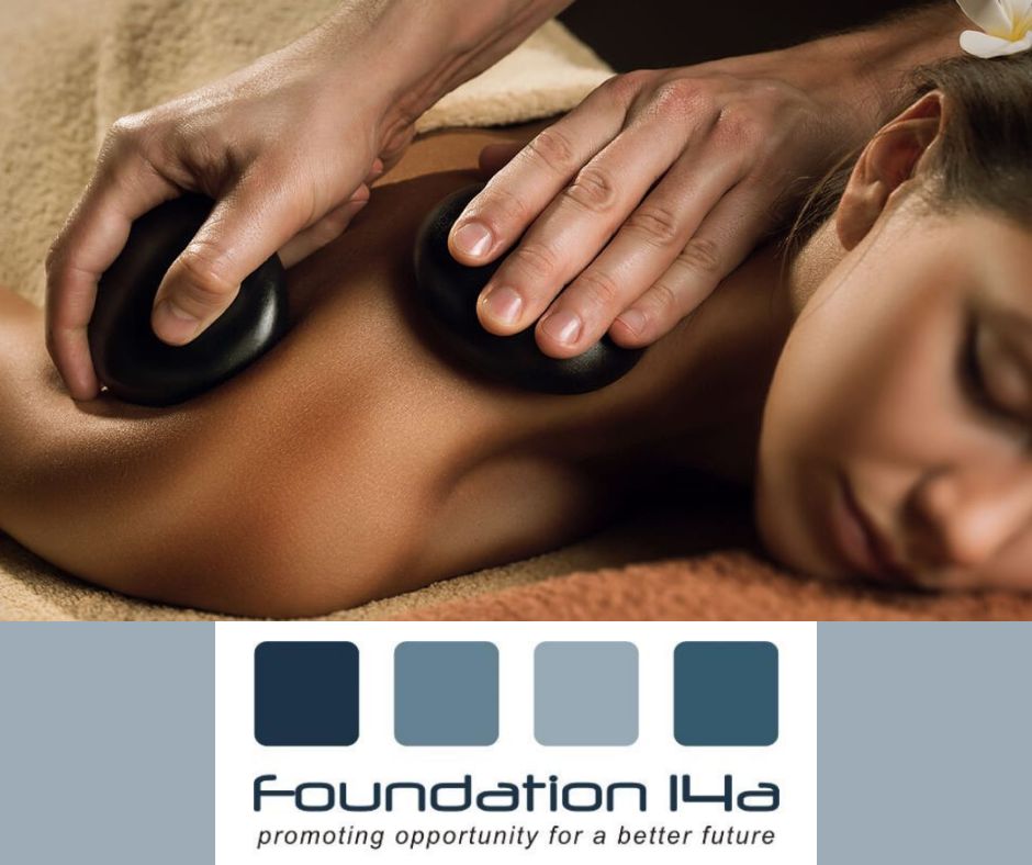 Close up of a therapist on a Hot Stones Therapy Course, using stones to massage a lady's right shoulder